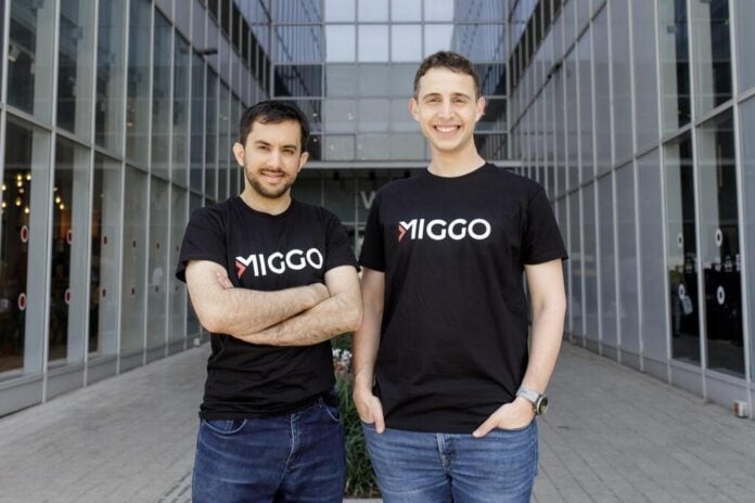 Two Miggo team members standing outside office Two Miggo team members standing outside office