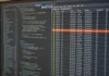 North Korea Runs Cloud Supply Chain Attacks Through the Blockchain, Unit 42 Finds A close-up of a computer monitor displaying a code editor and a connection-monitoring panel with outbound data.