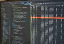 North Korea Runs Cloud Supply Chain Attacks Through the Blockchain, Unit 42 Finds A close-up of a computer monitor displaying a code editor and a connection-monitoring panel with outbound data.