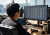 OpenClaw Security Risks Exposed as 31,674 Instances Spread in 12 Days A software engineer sits at a desk in a bright open-plan office, working on a large monitor displaying data.