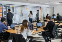 One Cyberattack Now Triggers Hundreds of Breach Reporting Obligations A spacious office with a long table of laptops, people working