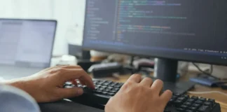 Anthropic’s AI Security Tests Broke Into Three Real Companies Close-up of hands mid-keystroke on a keyboard, with a blurred monitor