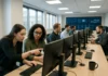 A bright security operations center with analysts at multi-monitor workstations, discussing and analyzing data in a collaborative setting.