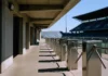 Ajax Cyber Breach Exposed 300,000 Fan Records and Stadium-Ban Controls Empty stadium concourse in bright daylight, featuring turnstile barriers and a view of the stands, shot from ground level.