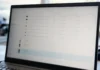 Helpdesk Impersonation: The Four Post-MFA Stages CISOs Need to Detect A laptop monitor displays a brightly lit authentication management console with a list of identity provider devices.