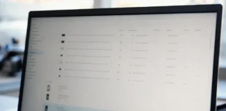 A laptop monitor displays a brightly lit authentication management