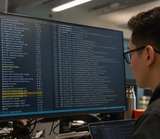 npm Supply Chain Security: Attackers Now Target Trust Paths, Not CVEs A person with glasses sits in front of a brightly